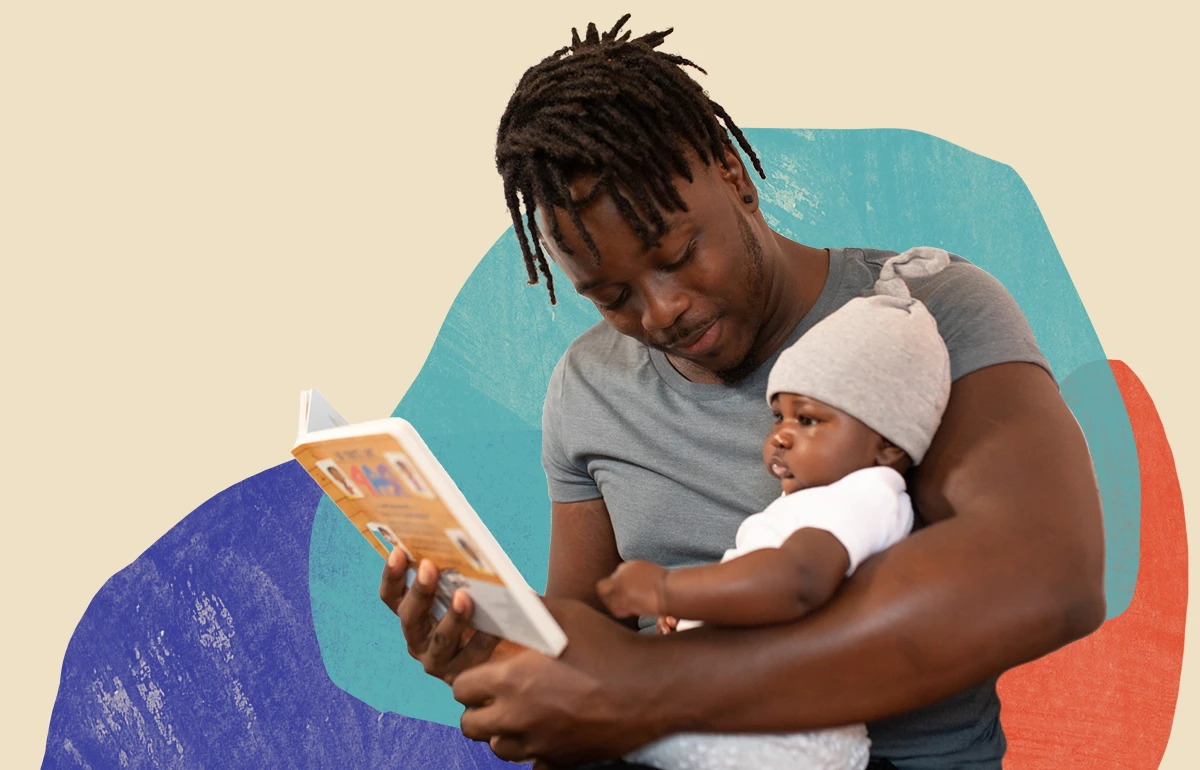 Young Black man cuddling and reading a picture book to a Black infant child.