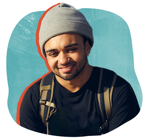 Young mixed race male with soft smile wearing a backpack and knit cap