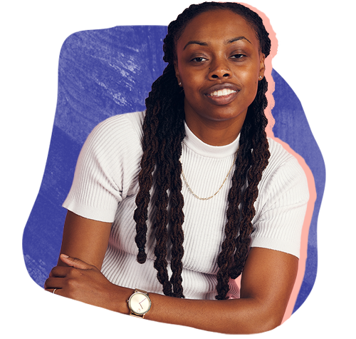 Young black woman with long braids leaning to the side with positive expression and arms folded.