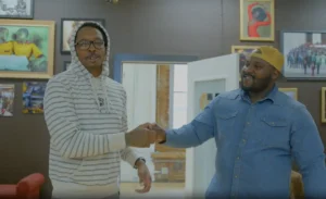 Two black men smiling and fist bumping